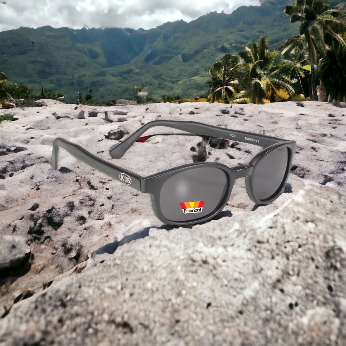 KD's 20019 sunglasses that fit under a motorcycle or ski helmet. Worn by SAMCRO bikers and Jax Teller in Sons of Anarchy. With a rugged matte black frame and polarized gray tinted lenses set in the mountains near the jungle.