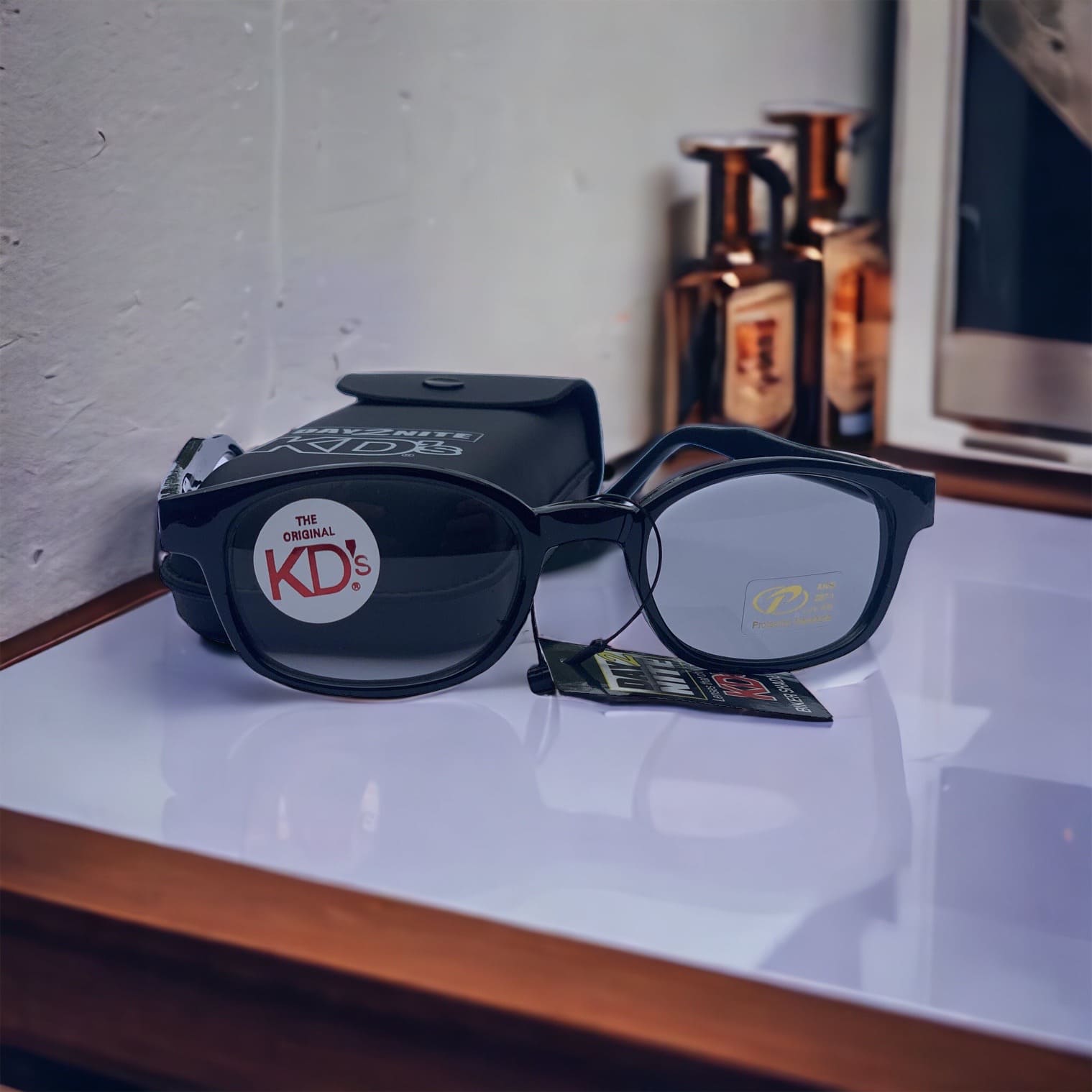 KD's 2011 sunglasses worn by Jax Teller in Sons of Anarchy with photochromic lenses placed on a lounge bar.