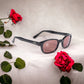 KD's 20120 sunglasses that fit under a motorcycle or ski helmet. With a stylish black frame and pink lenses in front of roses.