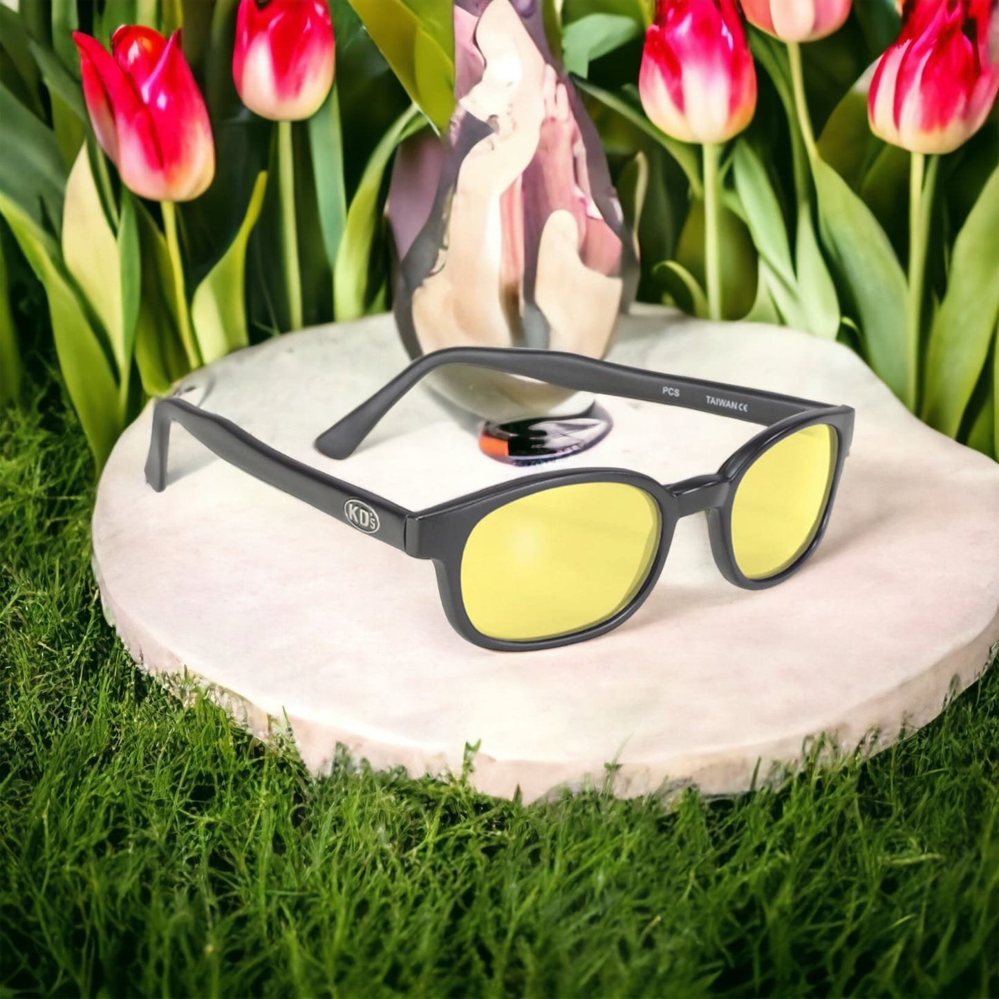 X-KD's 11112 large sunglasses for bikers with a sleek, solid black frame and yellow polycarbonate lenses set in front of tulips.