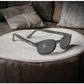 Great X-KD's 11120 sunglasses worn by Jax Teller and the Sons of Anarchy bikers with sleek matte black frames and durable dark gray polycarbonate lenses sitting on a couch.